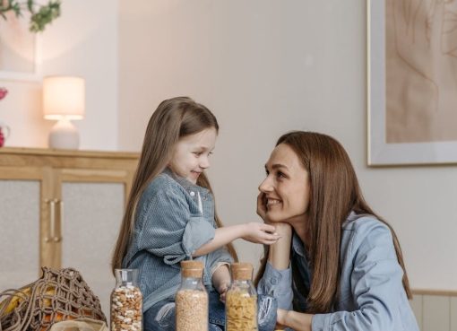 A loving mother and daughter enjoying quality time together in a cozy kitchen setting.